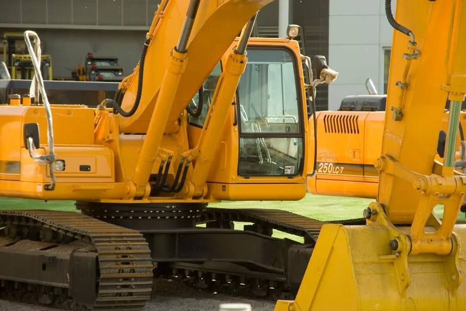 Close-up of yellow excavators at a construction site, showcasing industrial machinery and engineering.